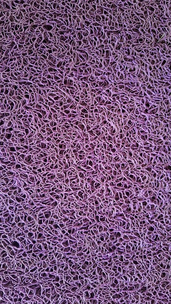Detailed texture of purple plastic fibers, creating an intricate and artistic pattern. Perfect for use in digital art, posters, or wallpapers. photo