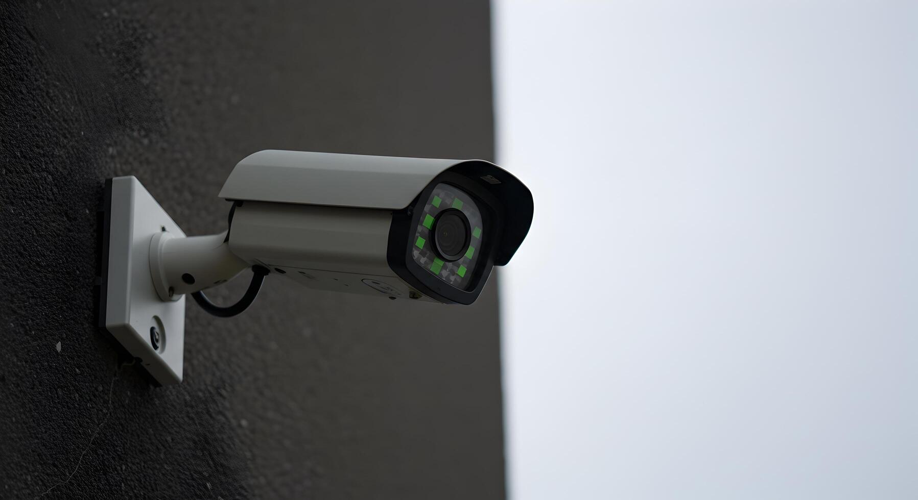 Surveillance camera mounted on a wall, security and public safety concept photo