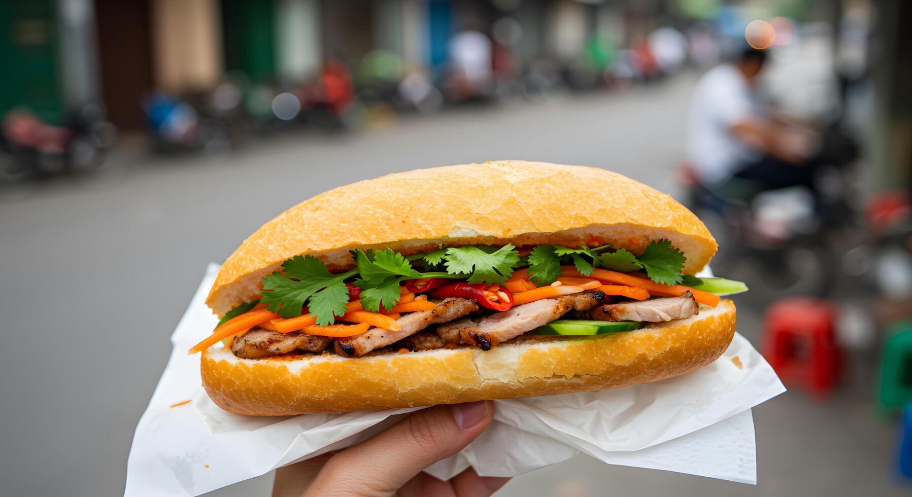 Authentic Vietnamese Banh Mi Sandwich in Hand, Street Food Culinary Delight photo