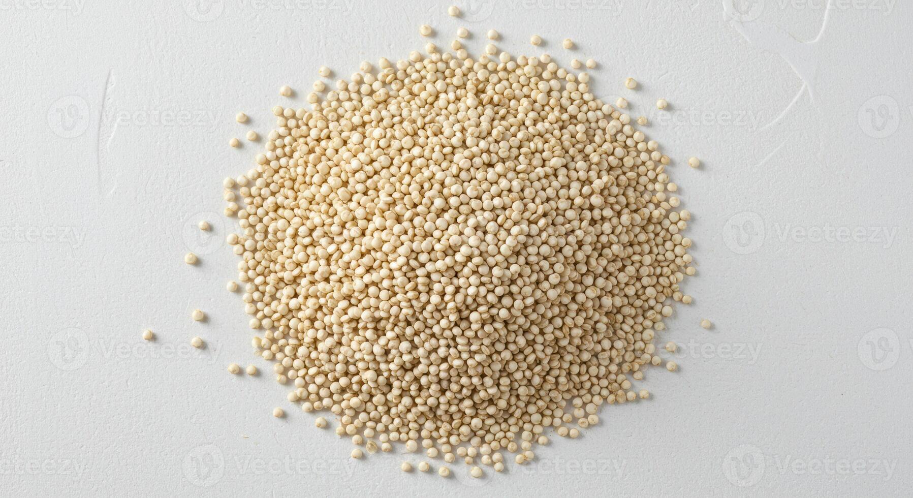 A top down view showcases a generous mound of quinoa, perfectly arranged on a white backdrop. photo