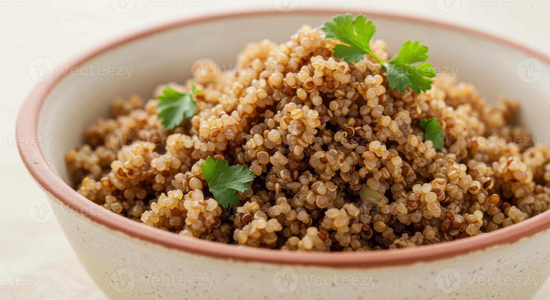A close up of a bowl filled with cooked quinoa and garnished with fresh parsley. photo