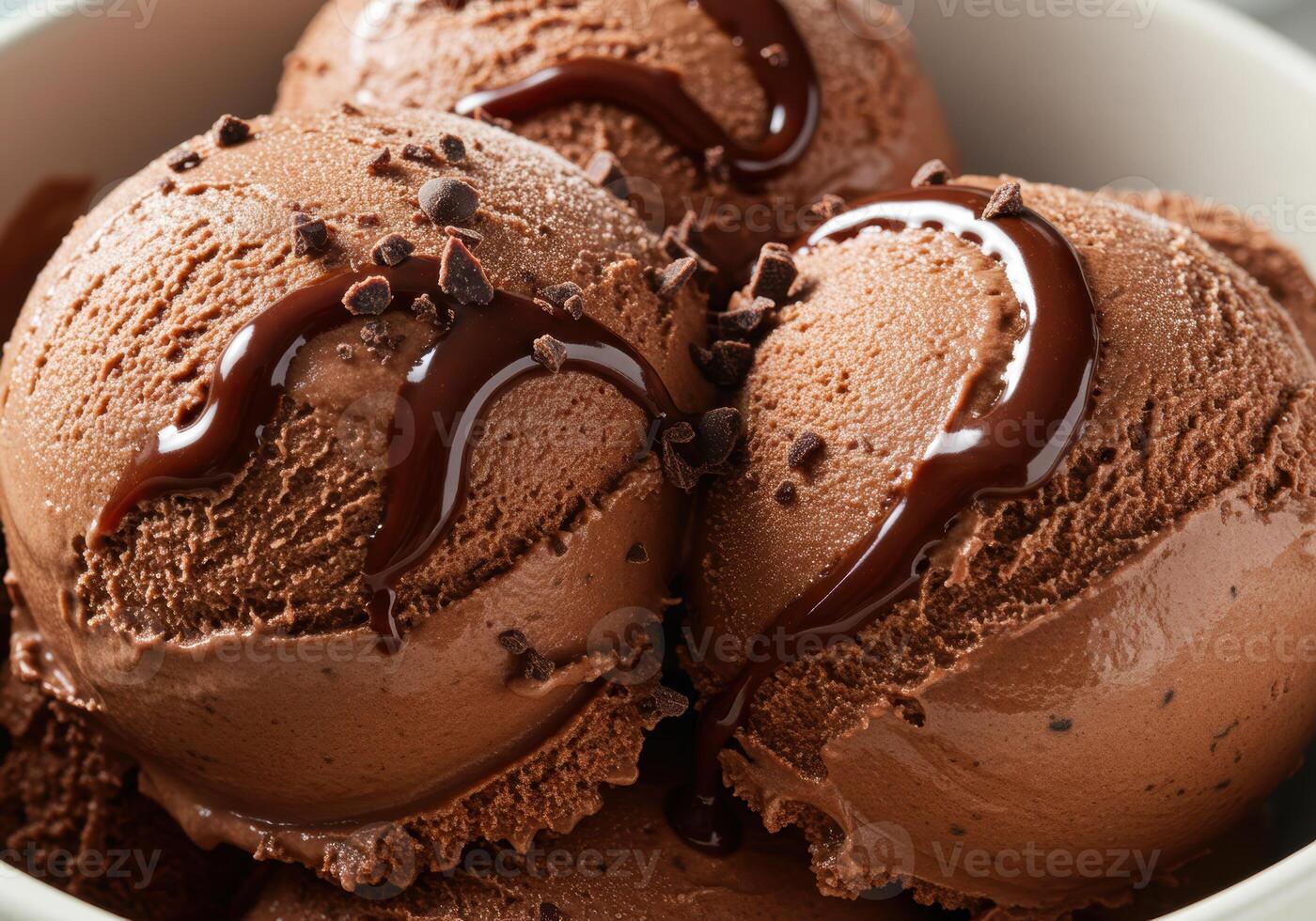 A delightful image showcasing a bowl of decadent chocolate ice cream with drizzled syrup and chips. photo