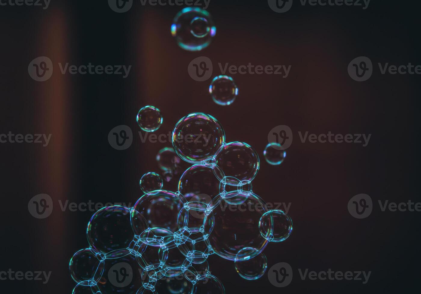 A cluster of soap bubbles, showcasing iridescent colors, rising and floating in the air. photo