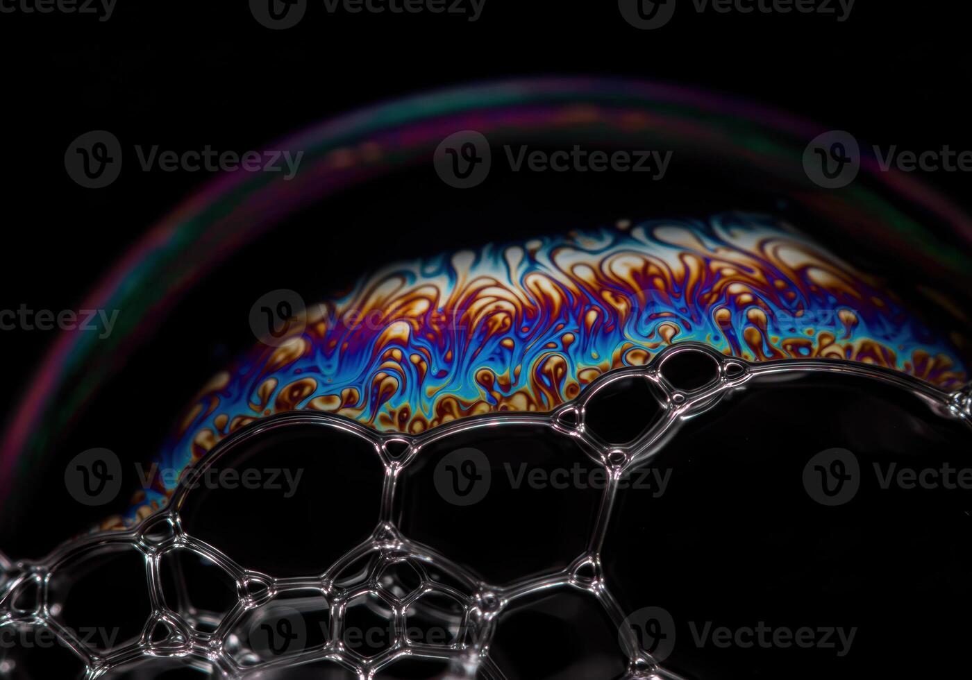 Vibrant colors dance across a soap bubble surface, creating a mesmerizing, detailed display. photo