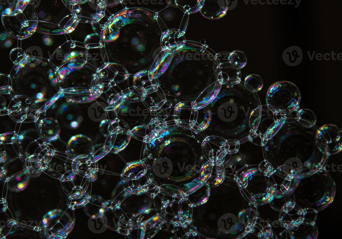 A mesmerizing arrangement of connected soap bubbles with rainbow reflections. photo