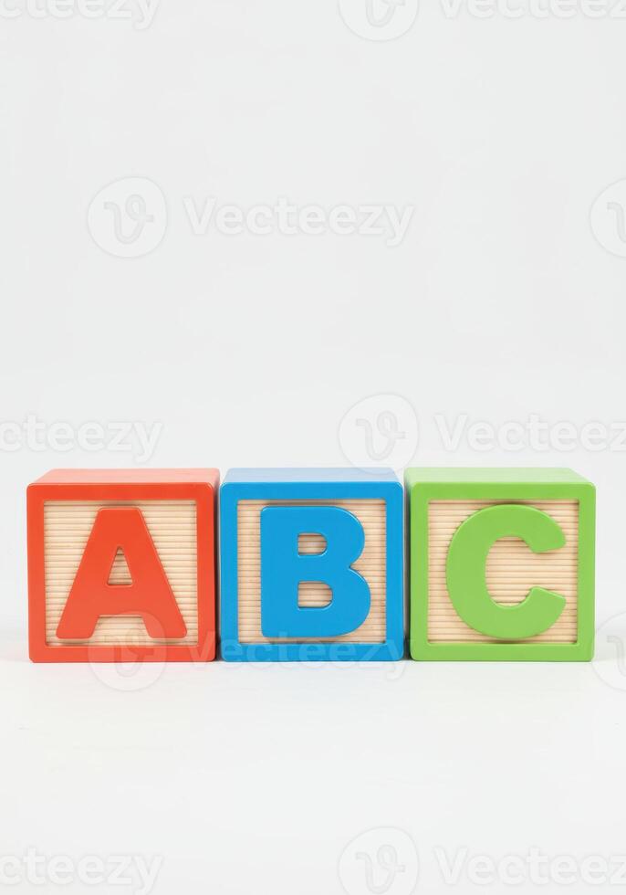 Three vibrant blocks, displaying letters A, B, and C, form an elementary learning tool. photo