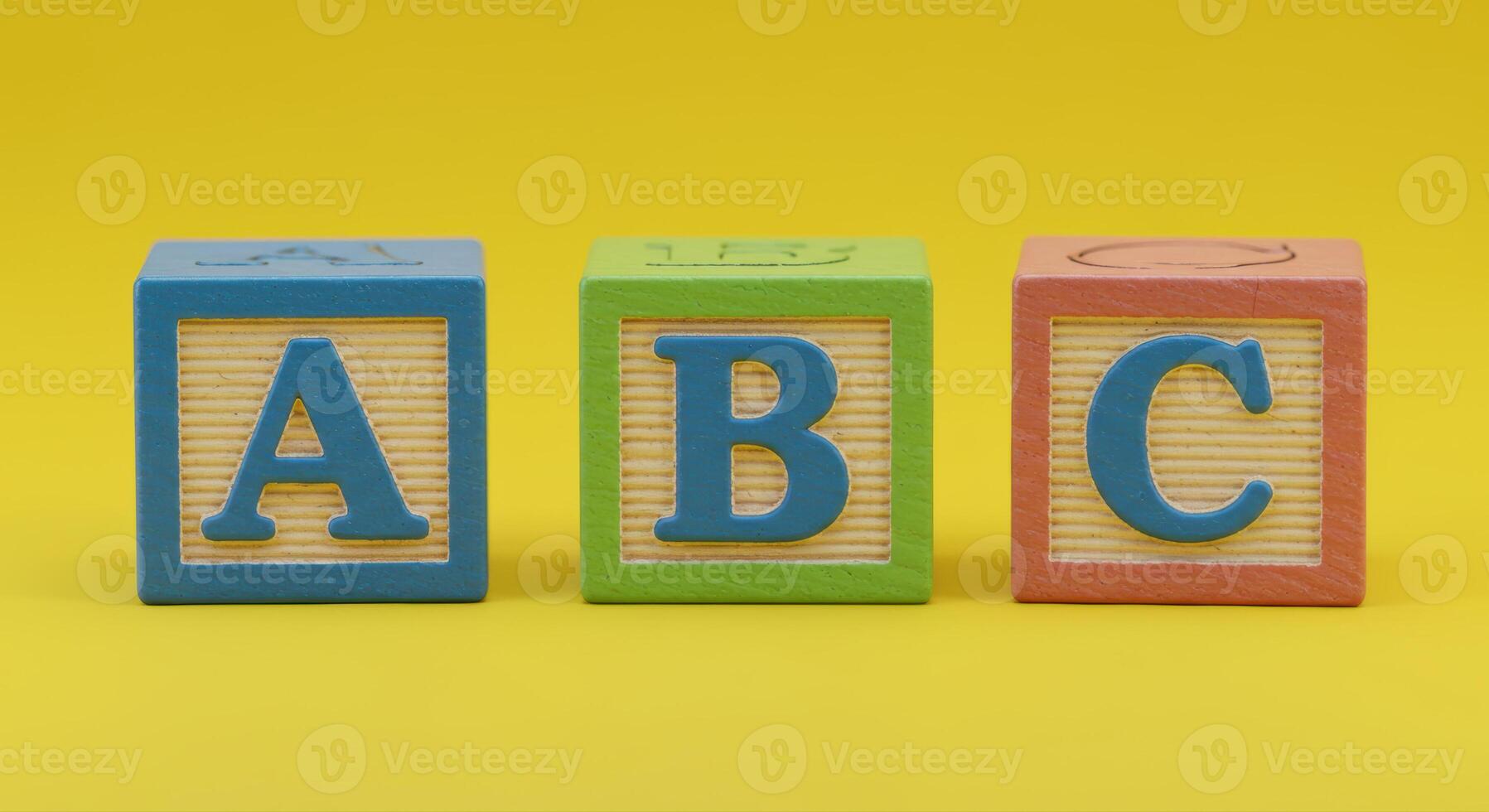 Three colorful wooden blocks displaying the first three letters of the alphabet. photo
