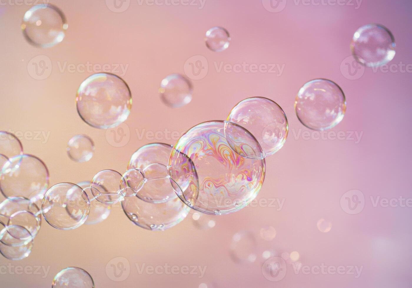 A cluster of transparent soap bubbles float gently against a soft gradient backdrop. photo