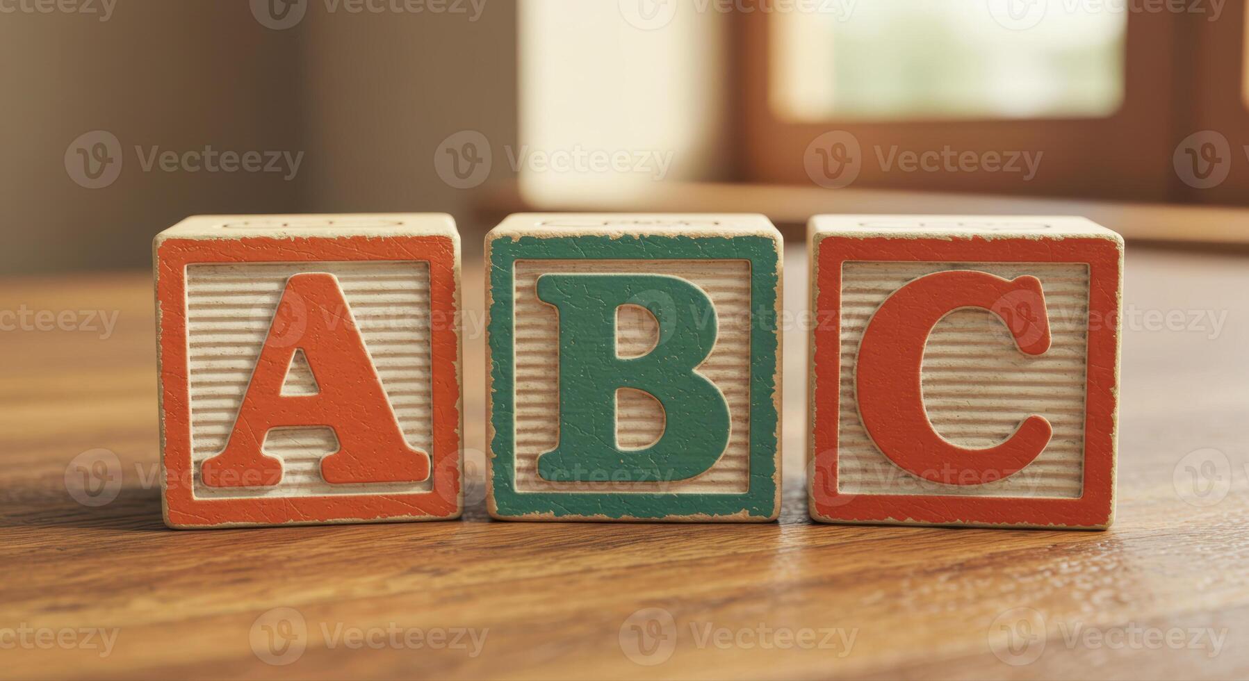 Three alphabet blocks showing a, b, and c resting on a wooden surface. photo