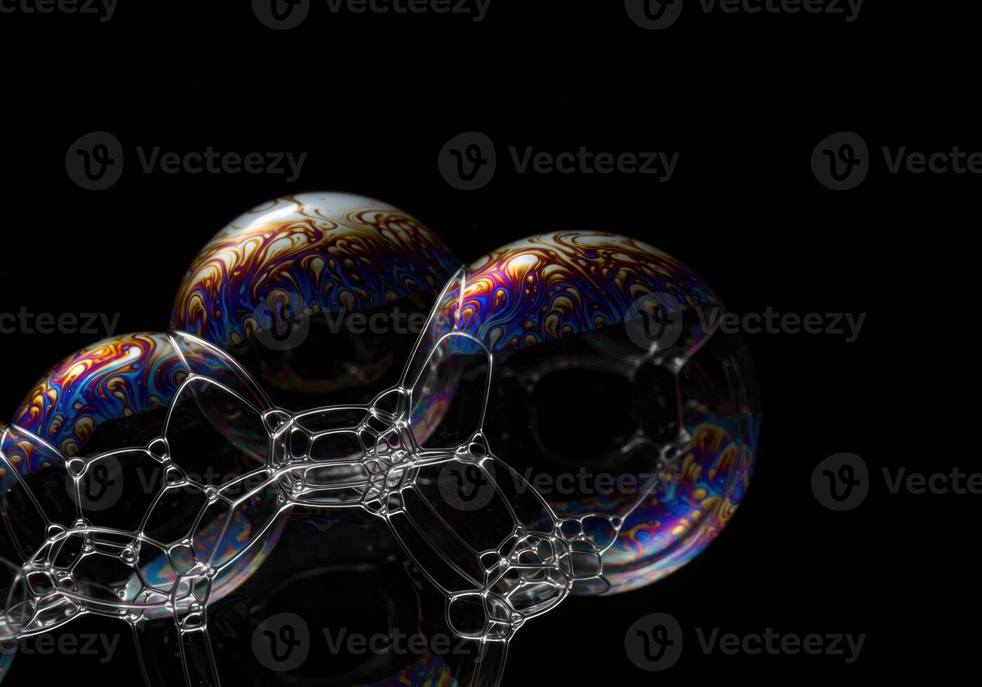 Vibrant soap bubbles exhibit intricate patterns in a close-up shot against a black background. photo