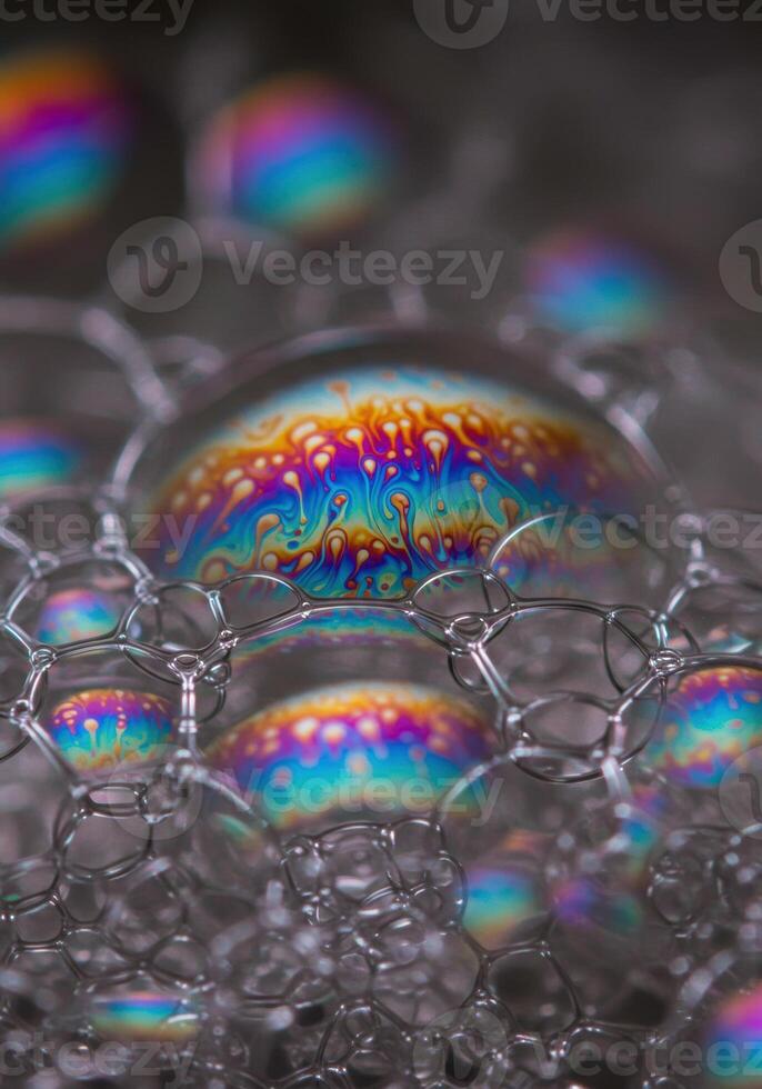 Captivating close up of soap bubbles displaying a mesmerizing spectrum of vibrant colors. photo