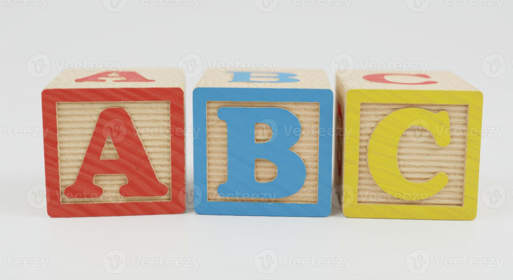Vibrant ABC wooden blocks spelling out the first three letters of the alphabet. photo