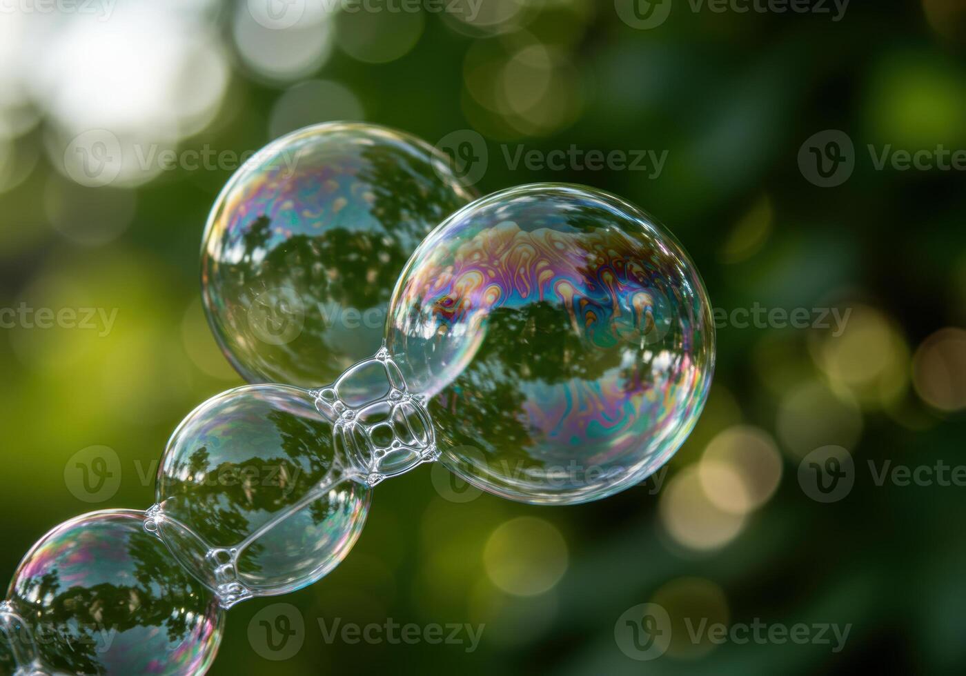 Beautiful bubbles floating with colorful reflections against a soft green background. photo