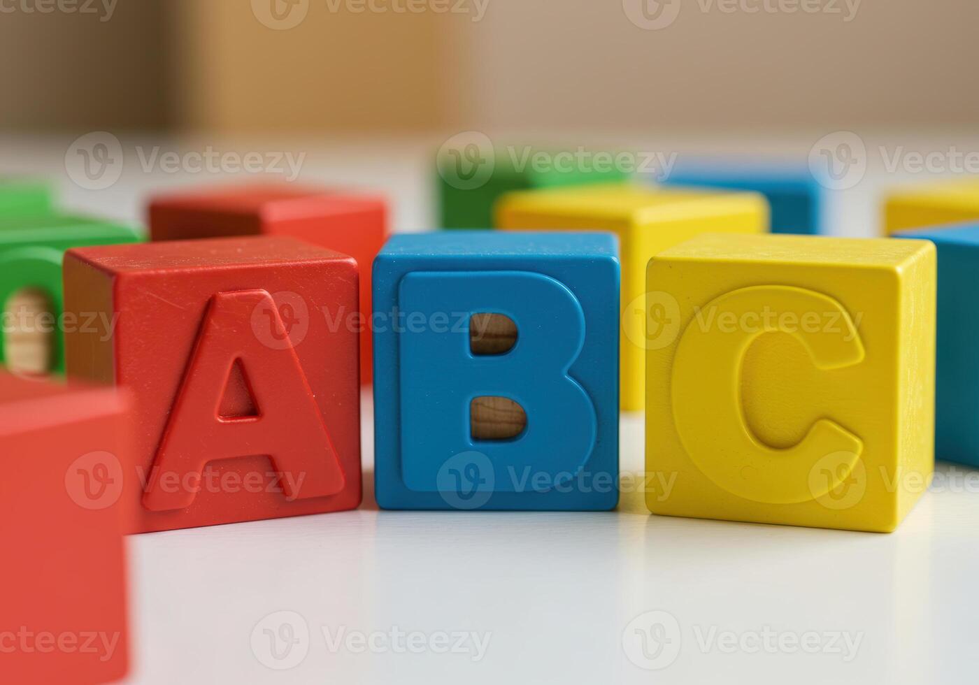 The vibrant wooden abc blocks are arranged on a white surface, perfect for learning. photo