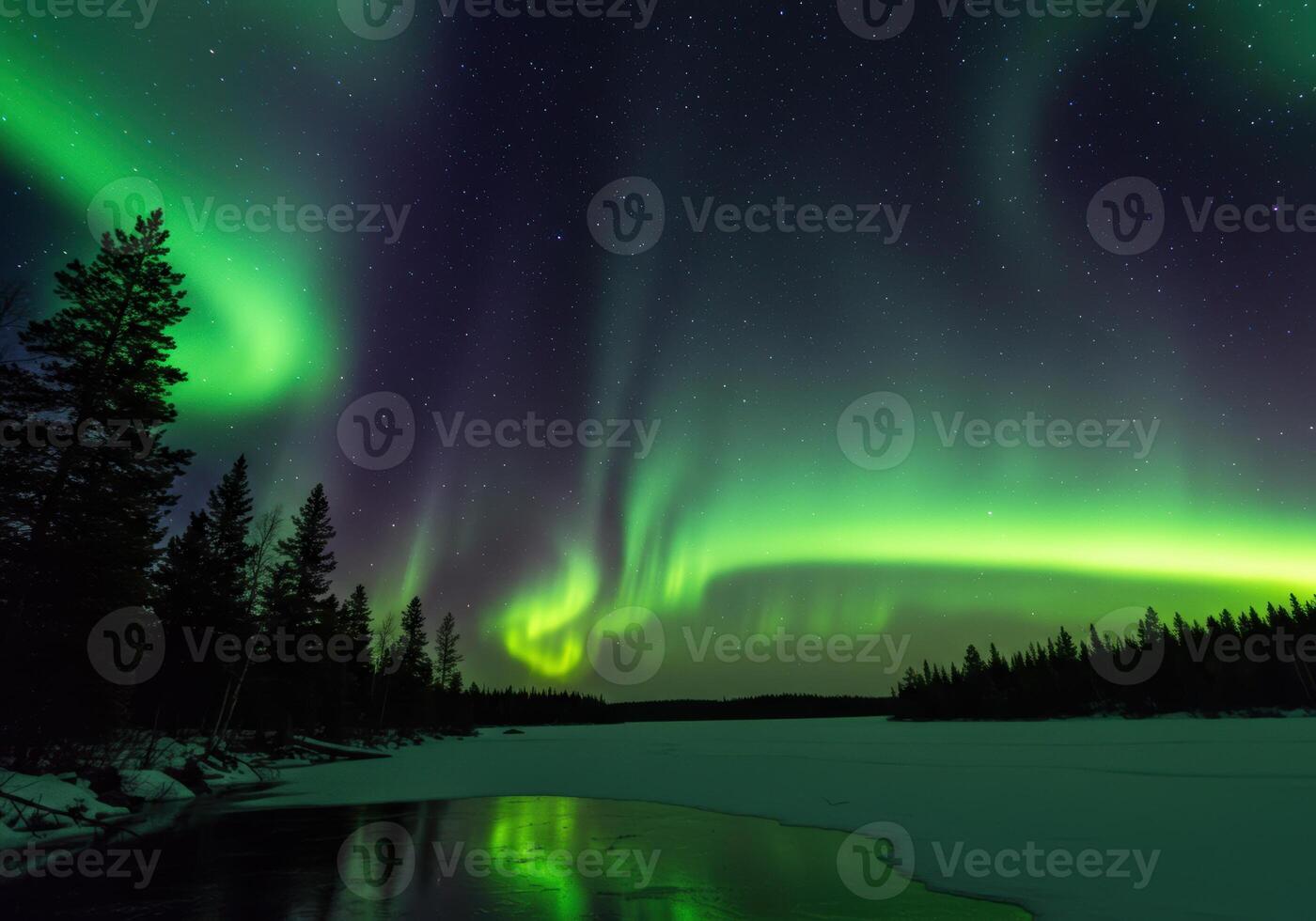 The captivating dance of the aurora borealis paints the night sky over a tranquil winter landscape. photo