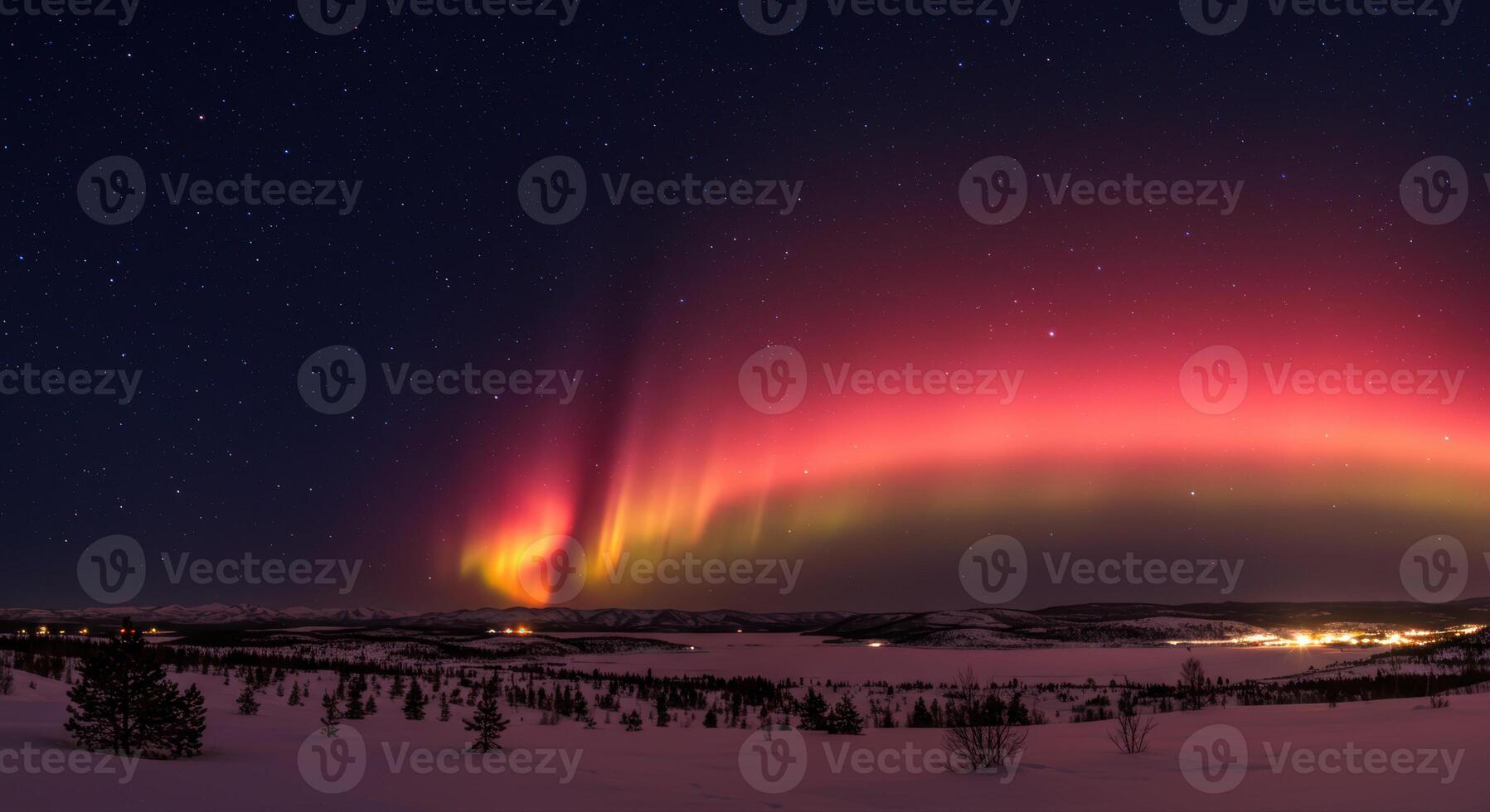 Stunning display of the aurora borealis dancing across the night sky over a snowy terrain. photo