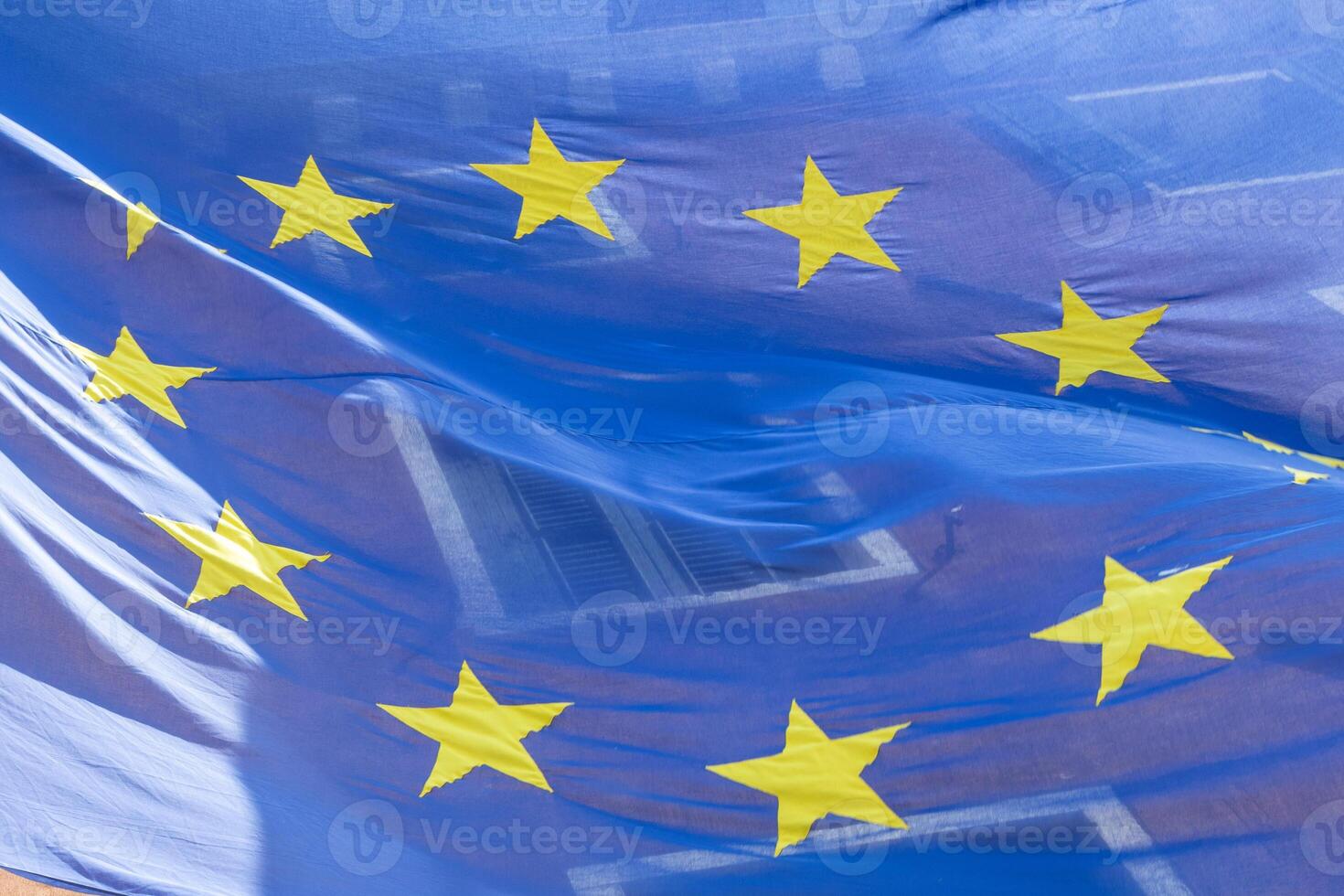 European Union Flag Symbolically Blending with Home Windows photo