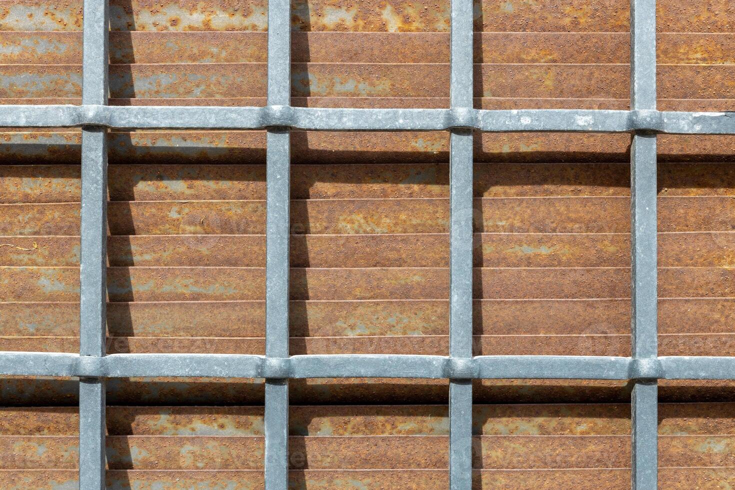 Galvanized Grid on Rusted Metal Surface photo