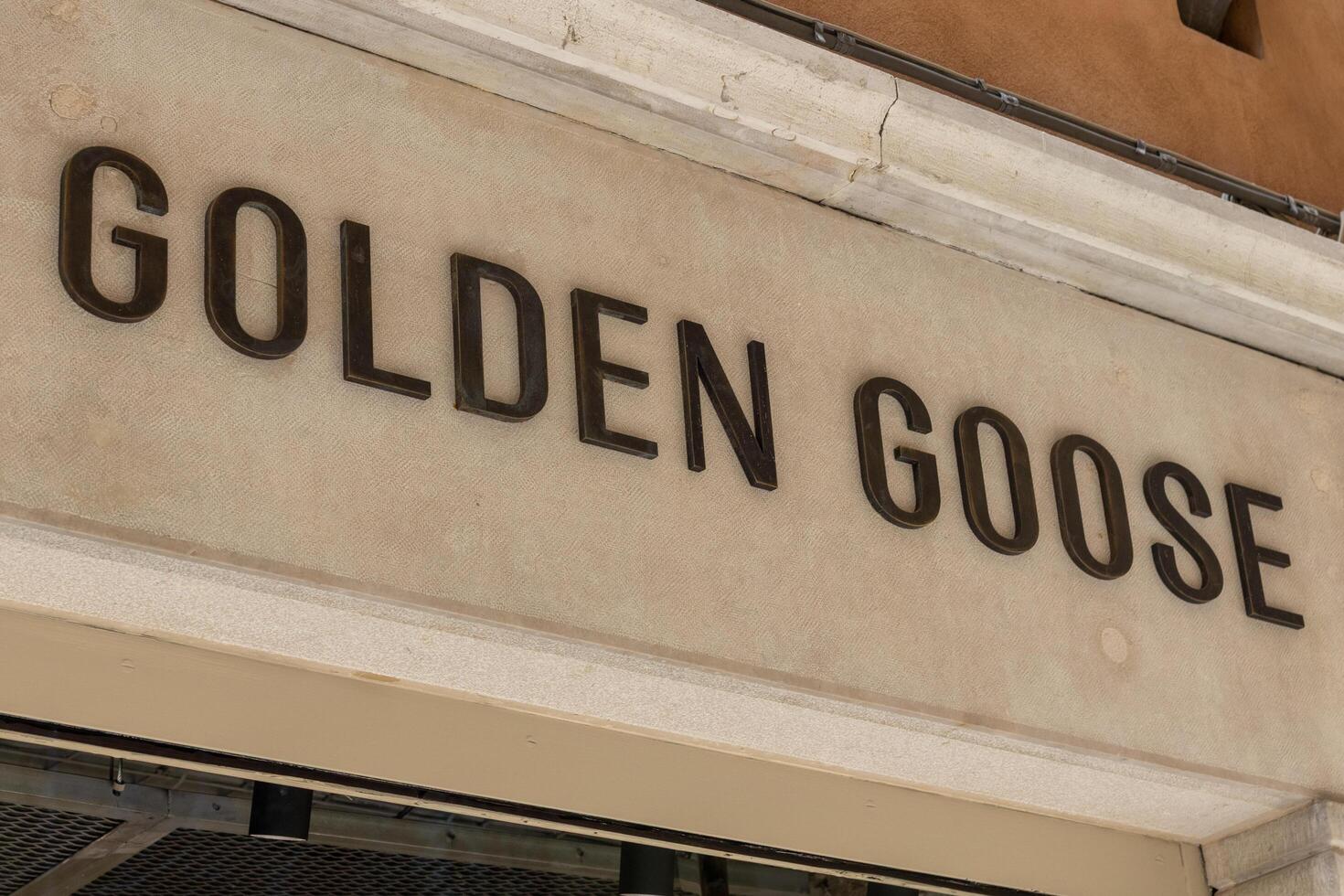 Venice, Italy - April 20 2025 Golden Goose brand logo on boutique facade in Venice city center photo