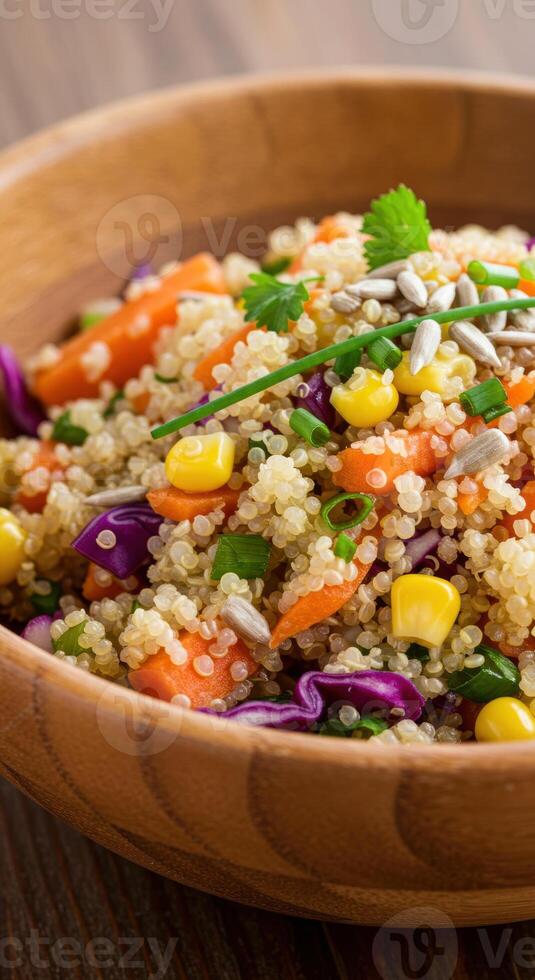A colorful and nutritious quinoa salad is presented beautifully in a wooden bowl. photo