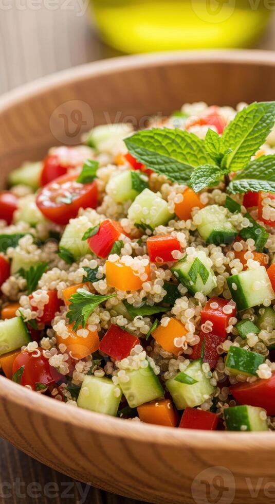 A colorful and refreshing quinoa salad filled with fresh vegetables and herbs, ready to eat. photo