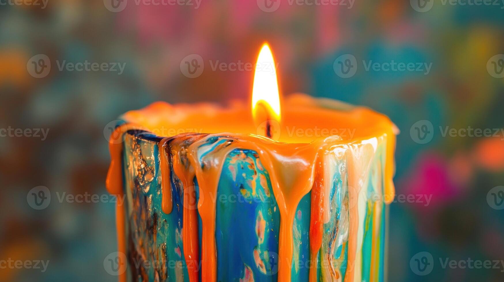 Burning vibrant candle with colorful drips photo