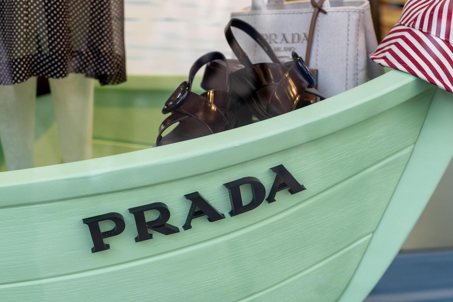 Venice, Italy - April 20 2025 Prada window display with summer fashion accessories and branding photo