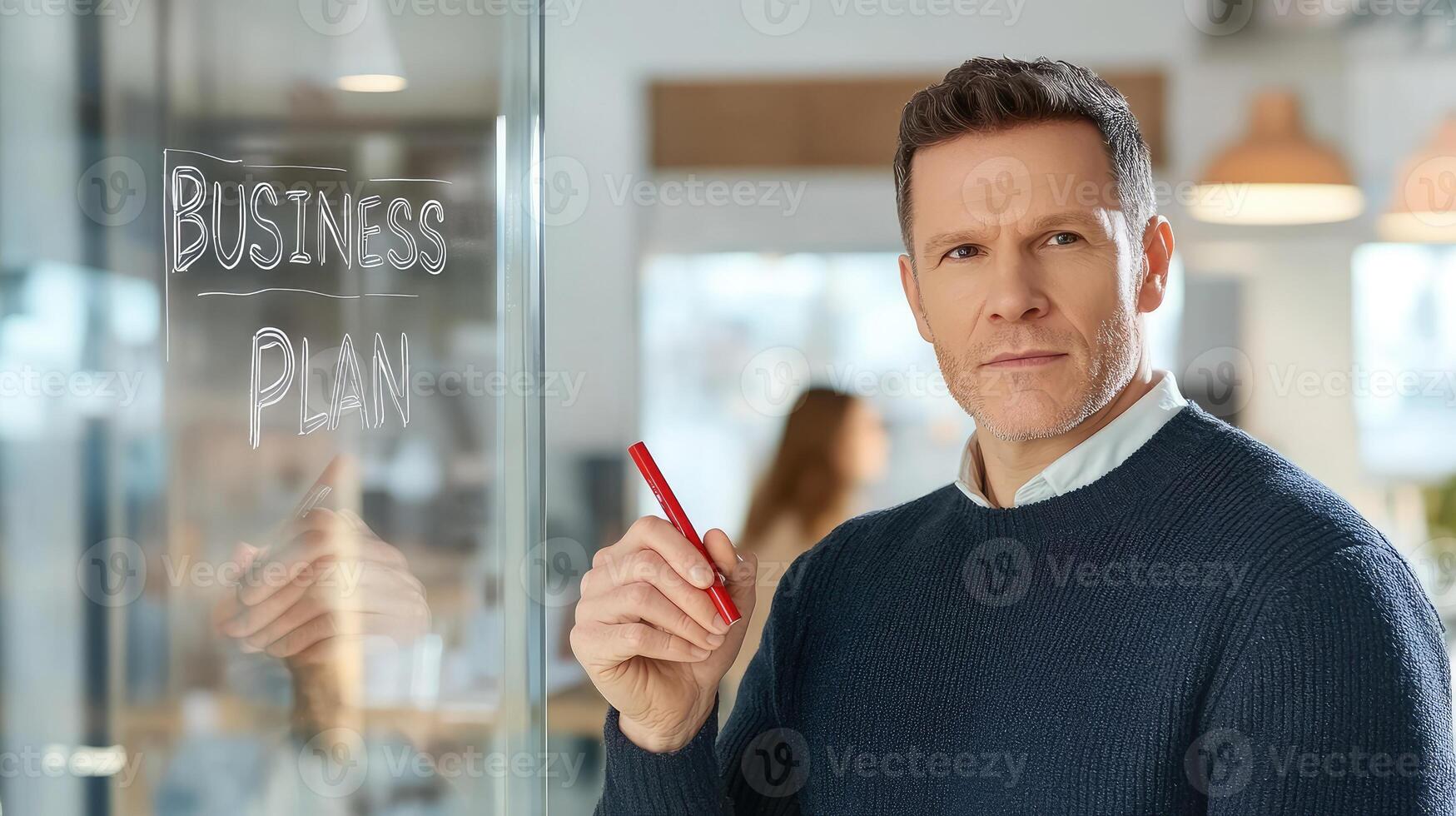 Confident entrepreneur formulating innovative business strategies on glass wall photo