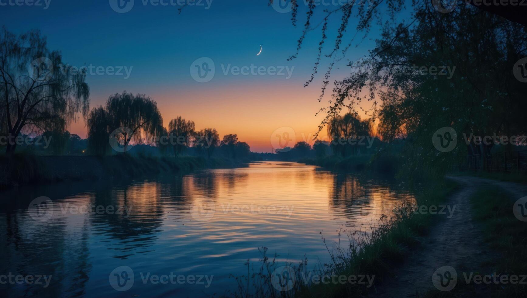 Serene River Flowing Under a Dusk Sky with Trees Silhouetted photo