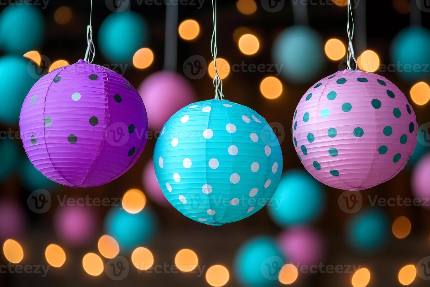Colorful paper lanterns hanging with bokeh lights in background photo