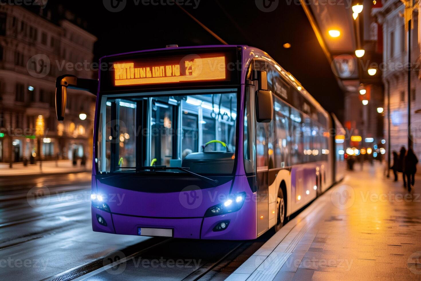 Modern purple bus waiting at night stop in city center photo