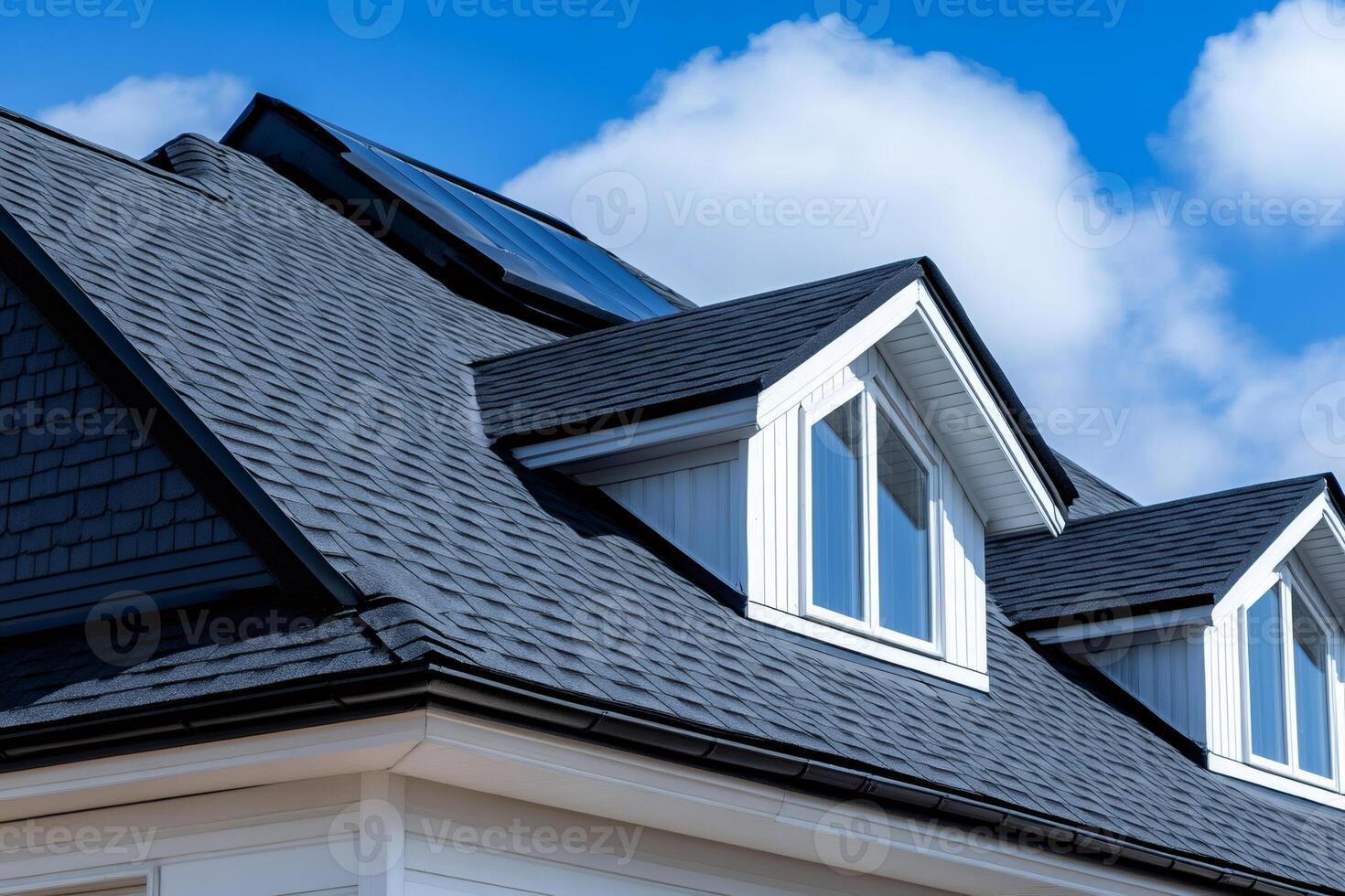 Modern house featuring skylights and dormer windows with asphalt shingles roof photo