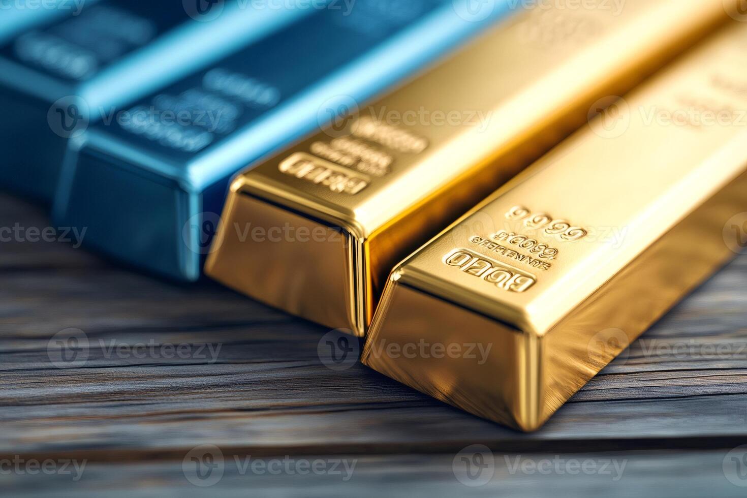 Gold and other precious metal bars resting on wooden table photo