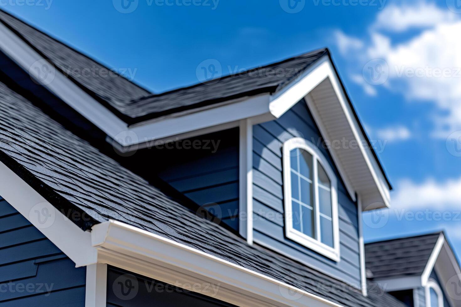 Modern suburban house featuring asphalt shingles roofing and dormer window photo