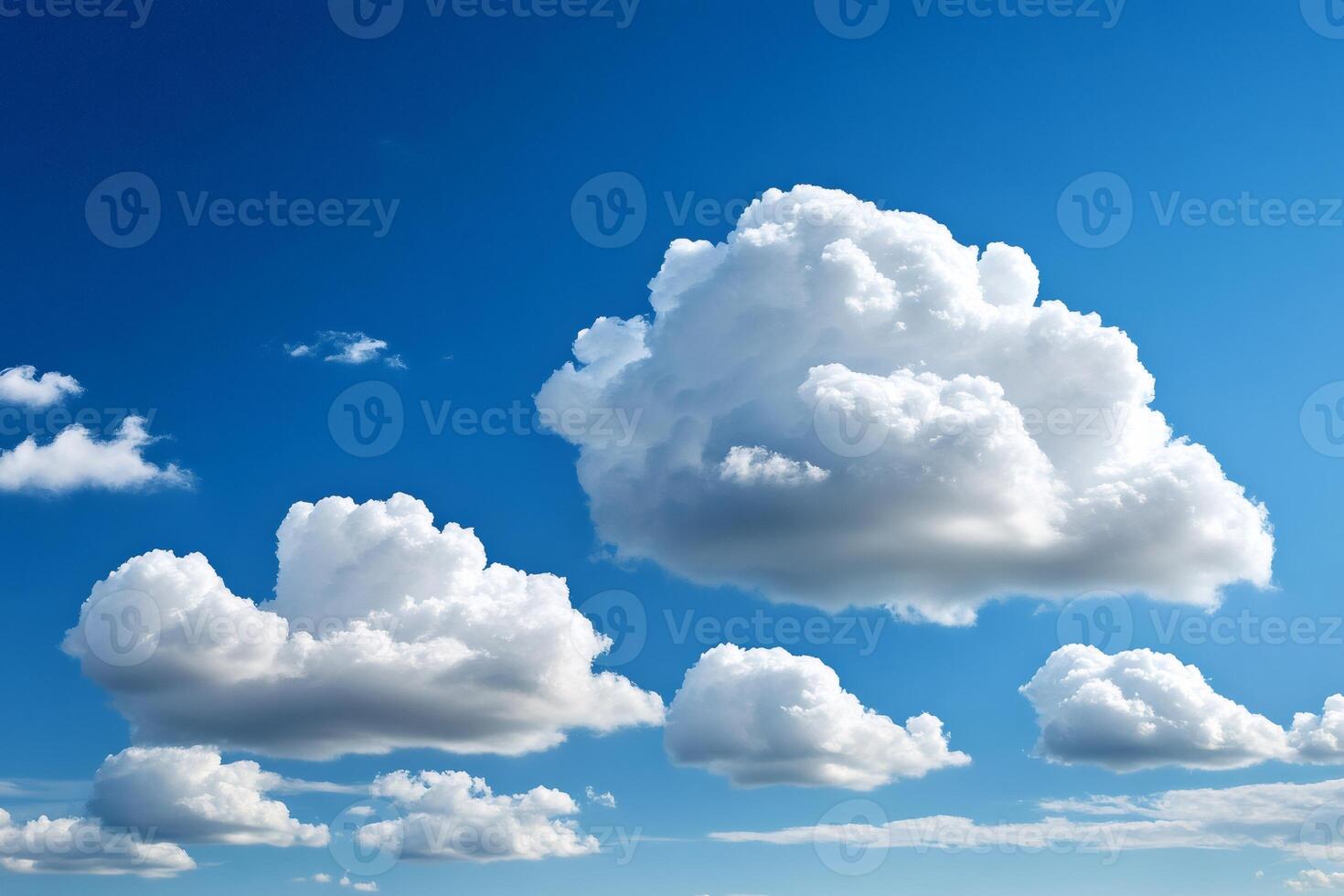White cumulus clouds drifting across a vibrant blue sky photo