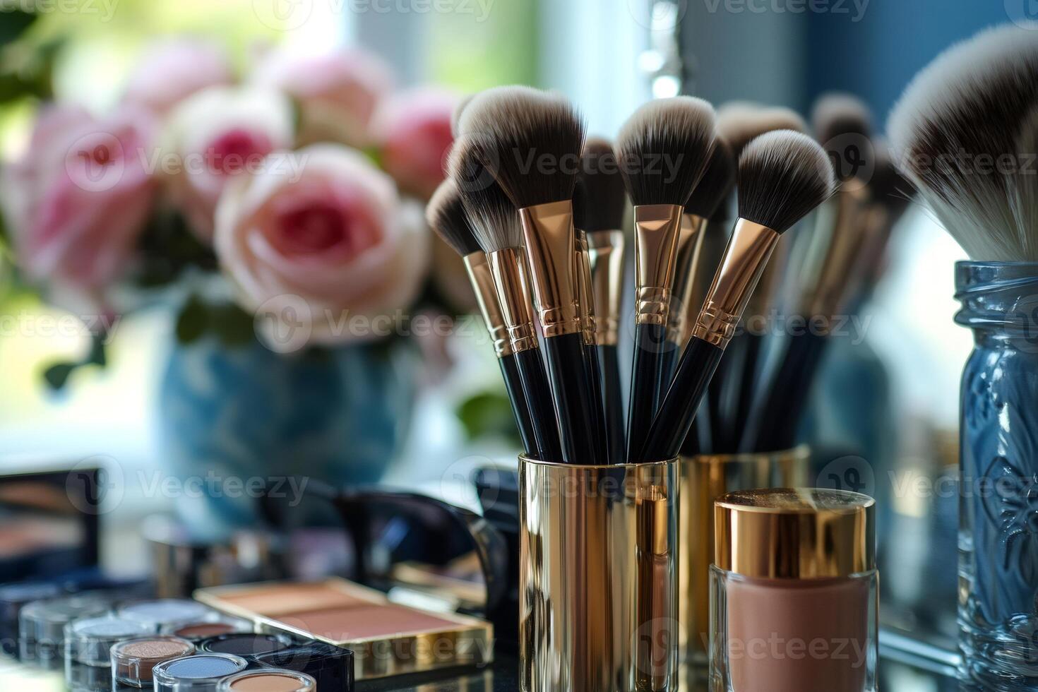 Makeup brushes resting in golden container on vanity table photo