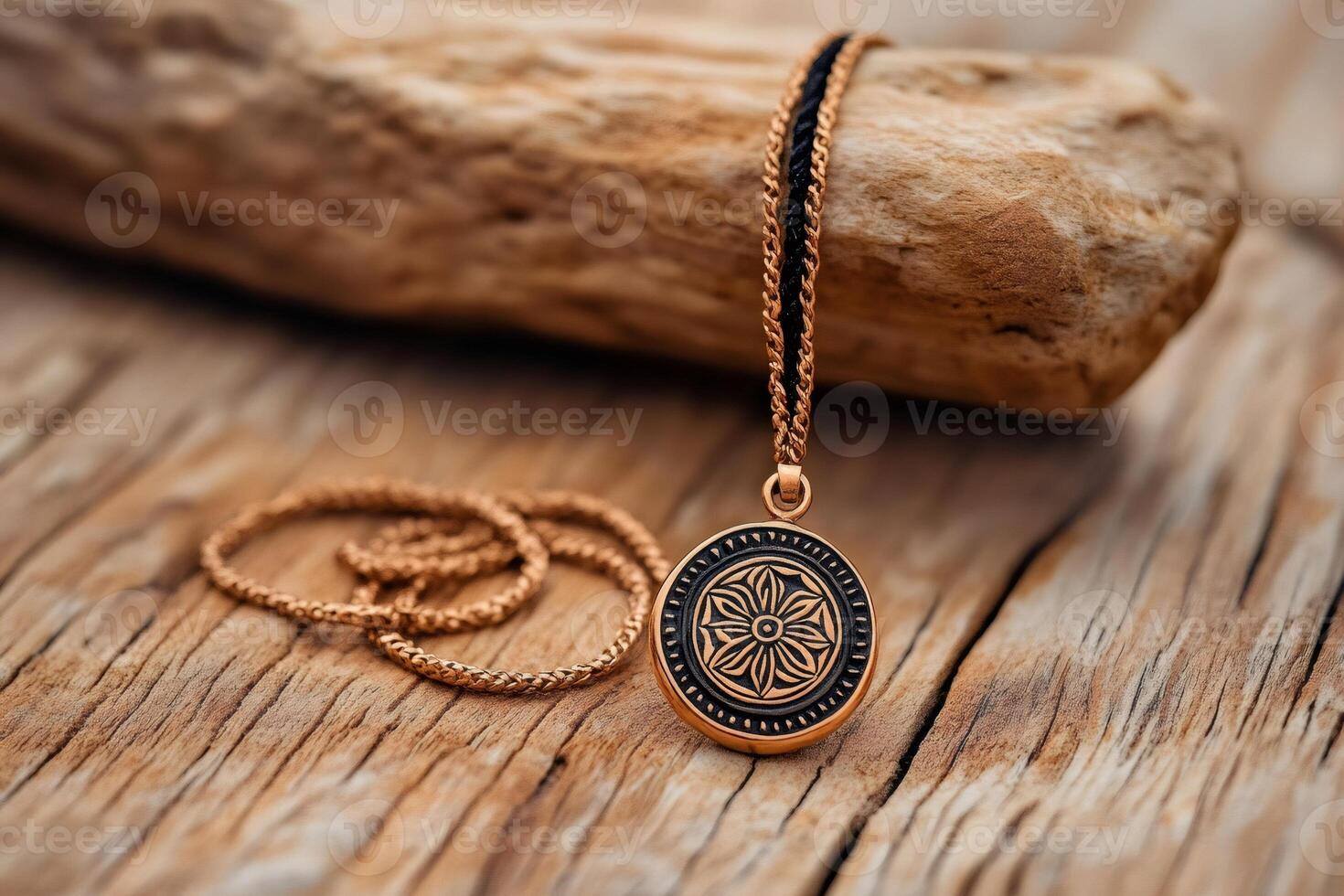 Golden medallion necklace resting on weathered wood photo
