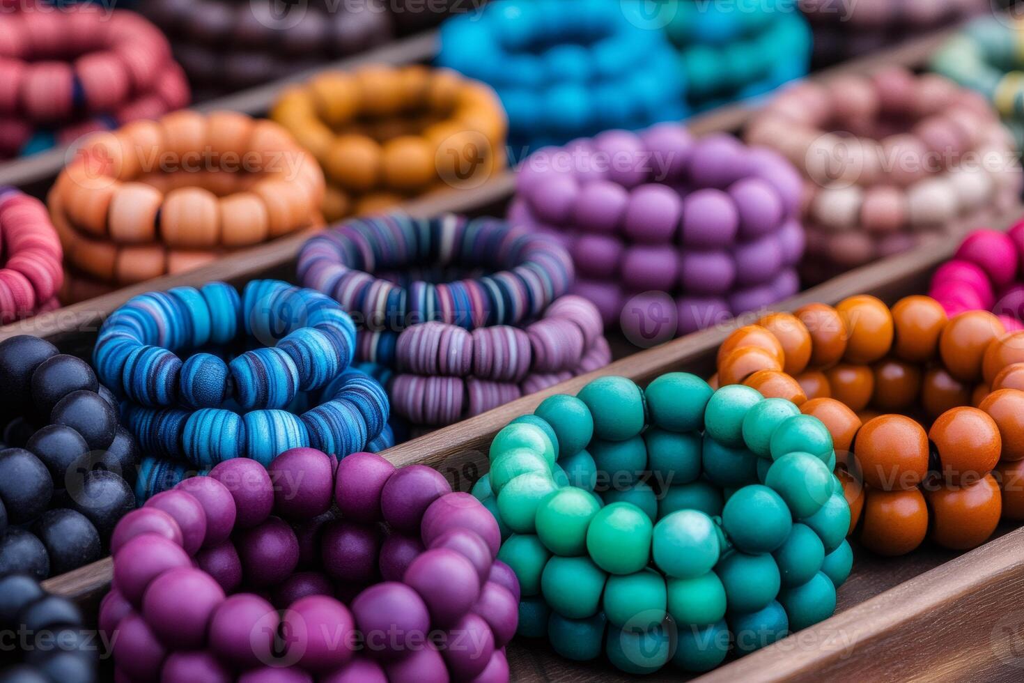 Colorful wooden bracelets displayed on a wooden shelf, representing fashion and craftsmanship photo