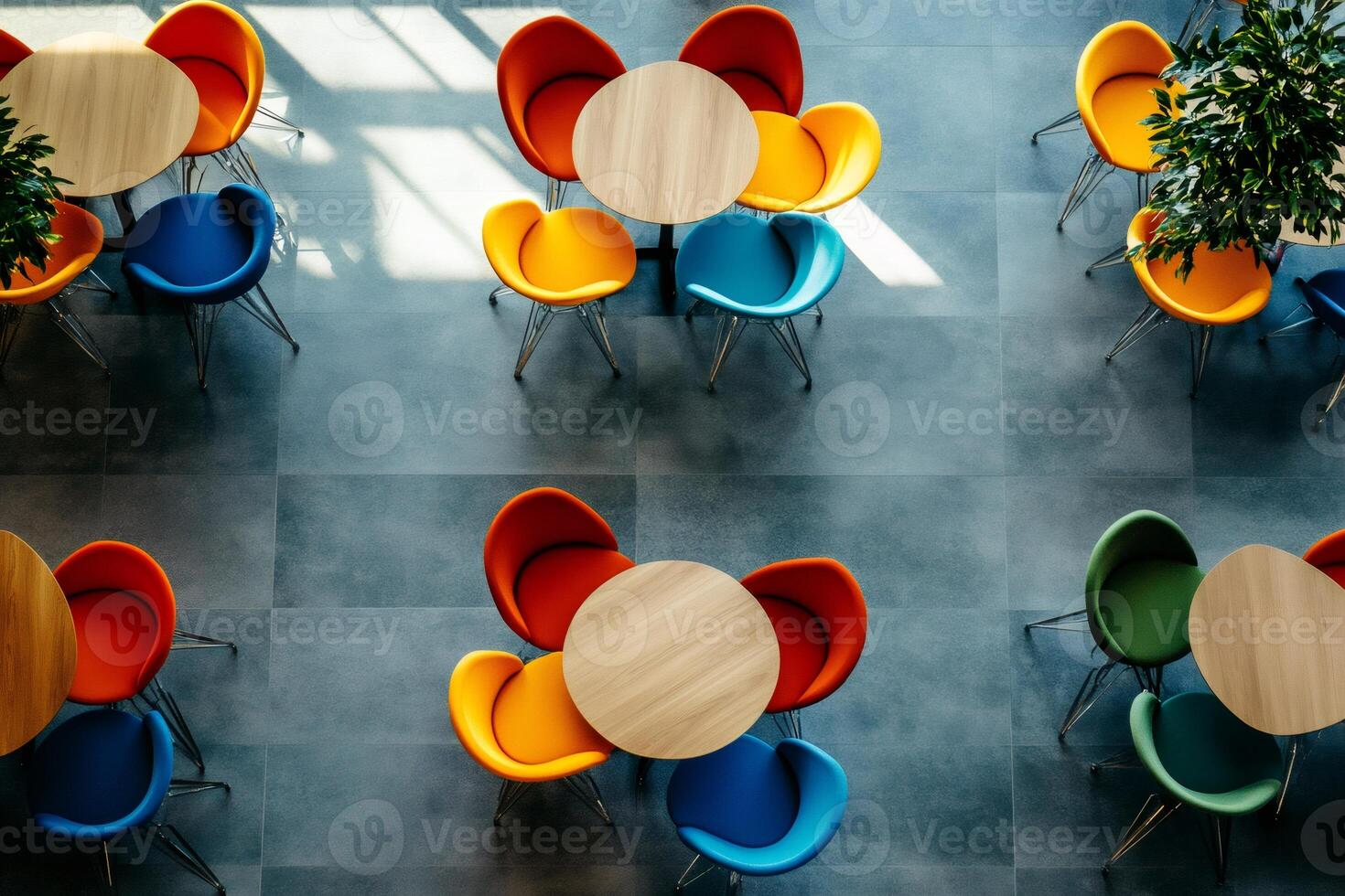 Colorful chairs and round tables creating a vibrant and modern cafeteria space photo