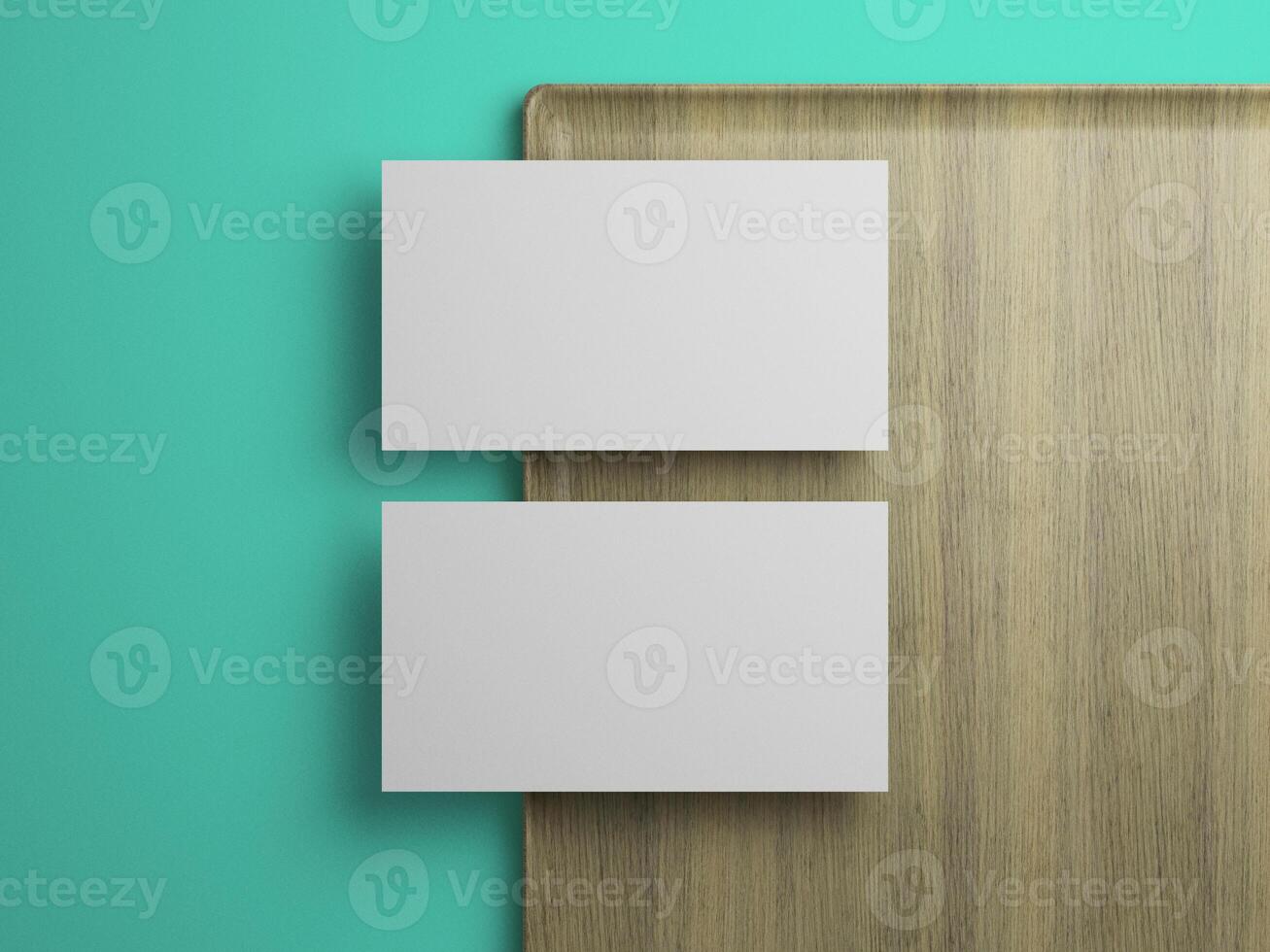 Two business card mockup in vertical alignment on wood tray, clean branding template on teal background. photo