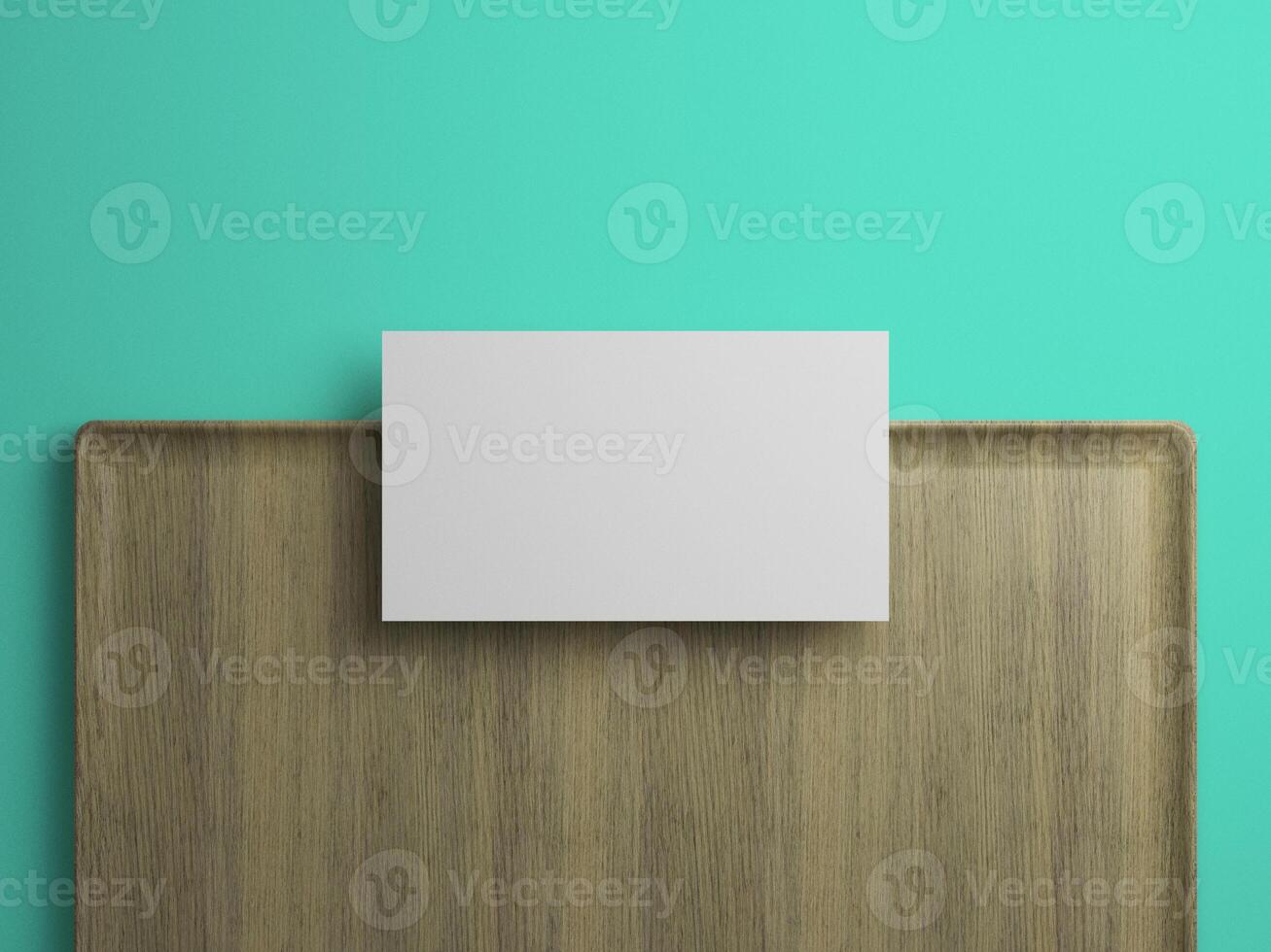 Top view of a blank business card over wooden tray with teal backdrop, ideal for identity showcase. photo