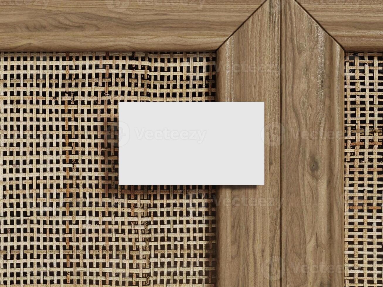Business card mockup on a woven rattan background, showing a single blank card with wood framing for a professional presentation. photo