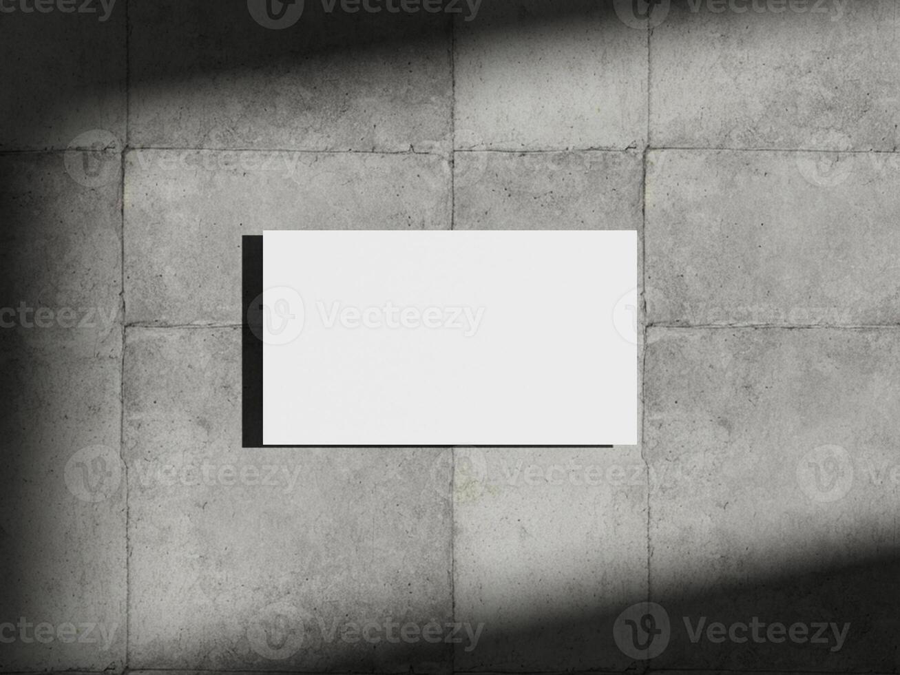 Business card mockup placed on concrete surface with soft shadows, perfect for showcasing branding and design concepts. photo
