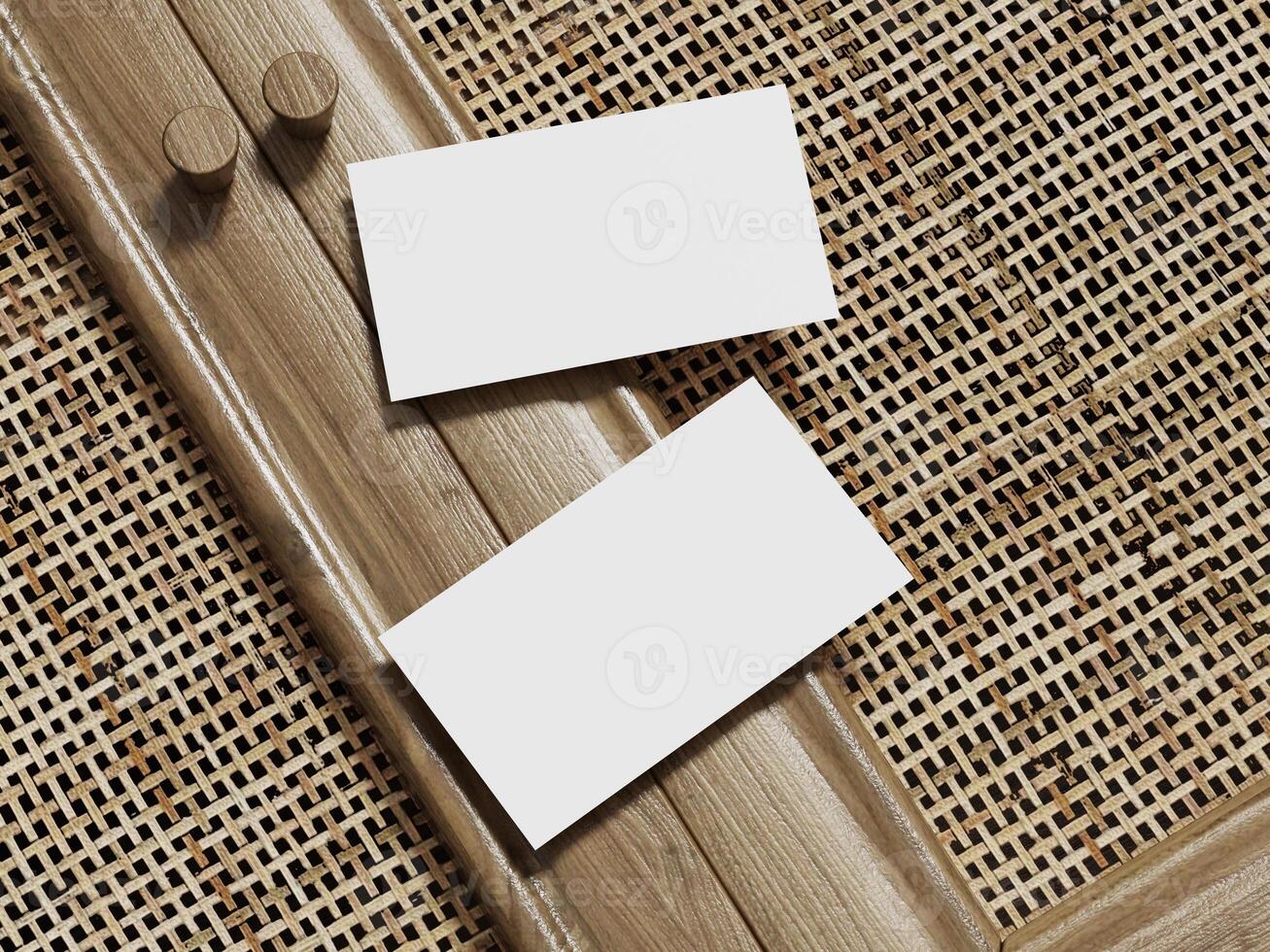 Business card mockup on a woven rattan background, with two blank cards framed in wood for a clean and sophisticated look. photo
