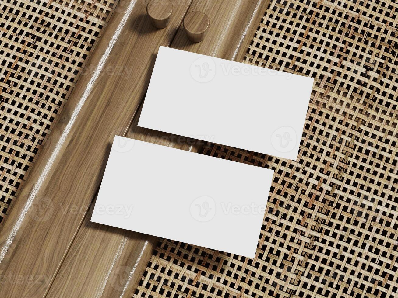 Two blank business cards positioned on a rattan background with a polished wooden border, ideal for professional branding. photo
