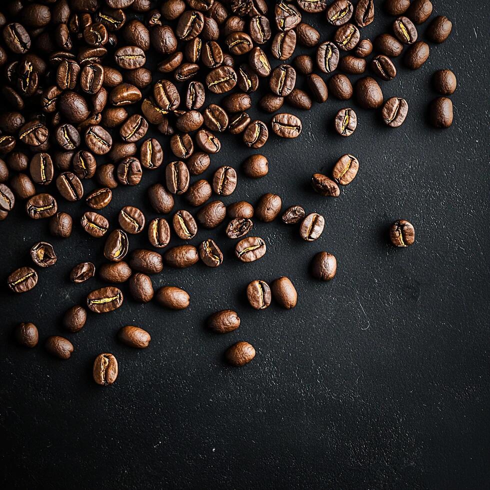 A close-up shot captures the rich, dark roasted coffee beans on a textured black surface. photo
