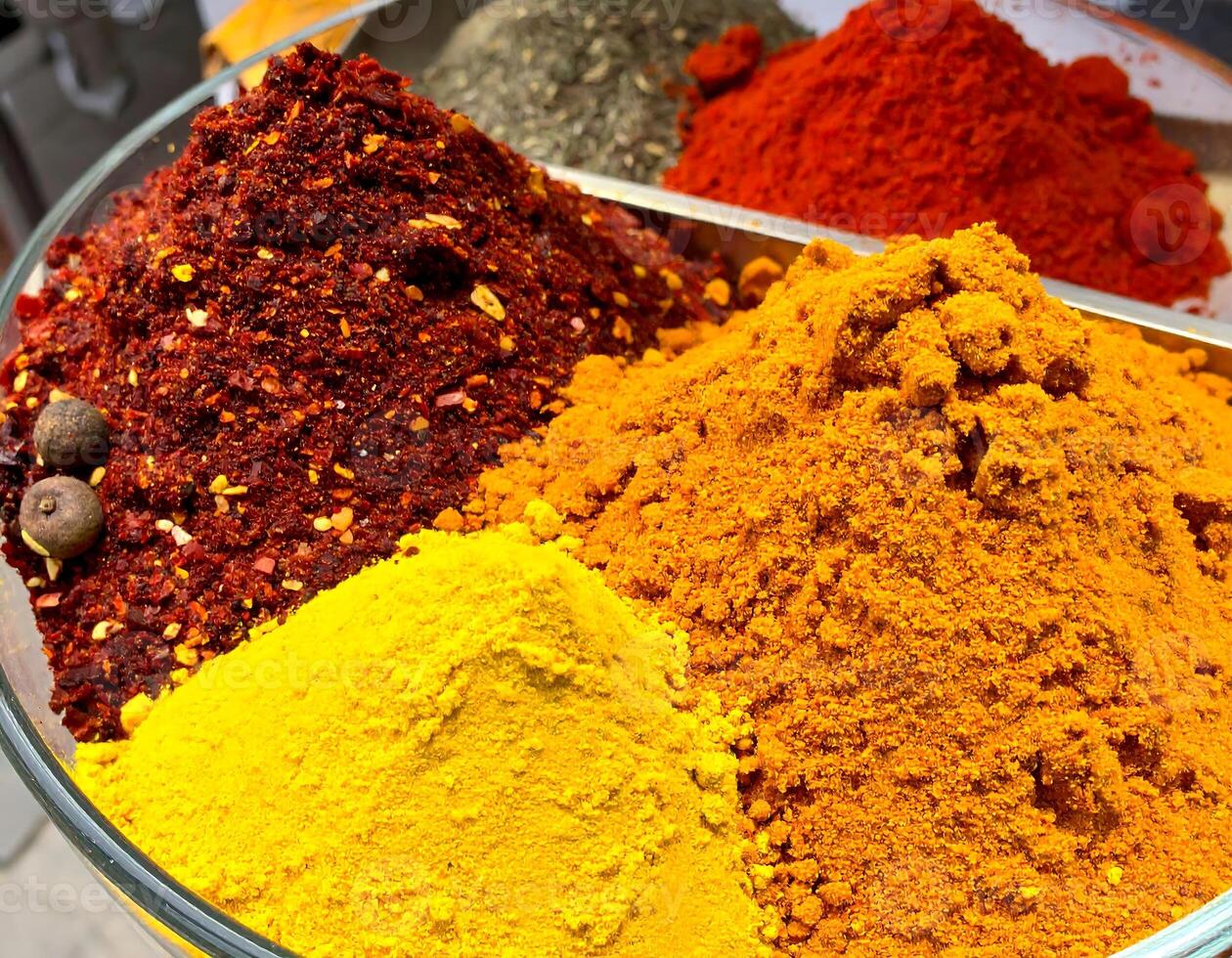 Colorful spices creating a vibrant and aromatic display in a glass bowl photo