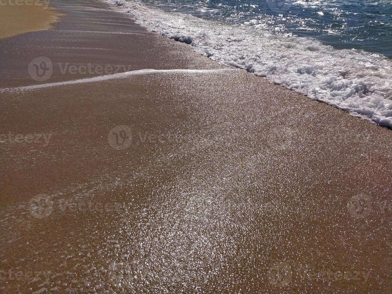 serene beach midday gentle waves lapping the shore and clear blue skies inviting relaxation photo
