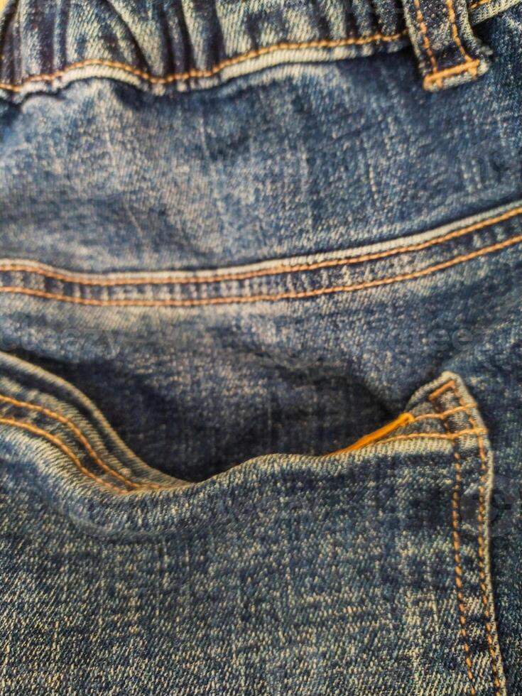 Closeup of blue denim jeans showing pocket and texture. Use for fashion, lifestyle, casual wear concepts. Perfect for backgrounds and textures. photo