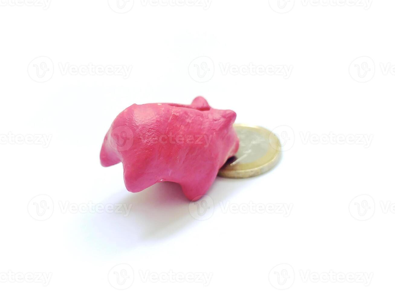 Pink piggy bank with coin, financial metaphor, on white. Illustrates savings, investment, finance, and economy. Ideal for business or personal finance content. photo